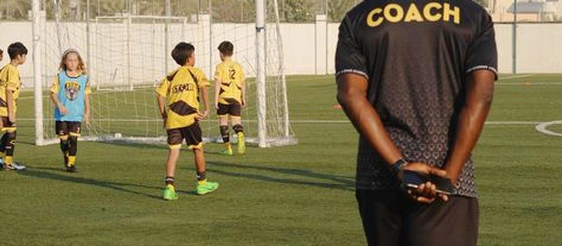 Coach running a youth training session